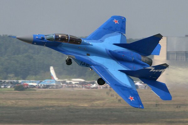 The blue fighter is taking off