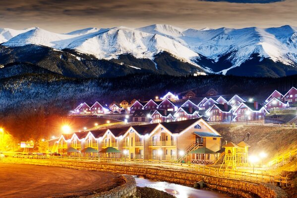 Cozy houses on the background of snow-capped mountains