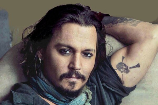 Johnny Depp with a tattoo on his arm