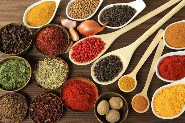 Various seasonings in wooden bowls on the water