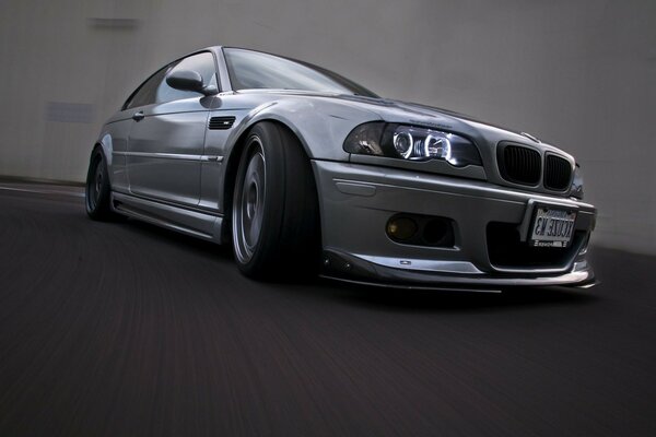 Silver BMW in a covered parking lot