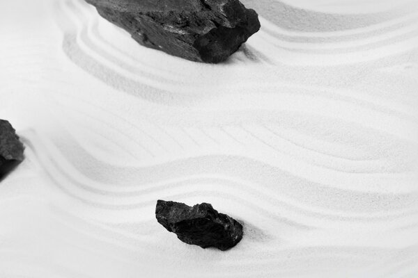 The stones are black on white cement waves