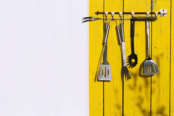 A set of cutlery hanging on wood