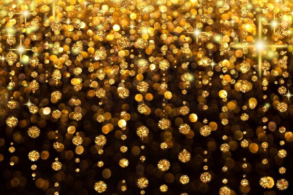 Curved golden droplets on a black background