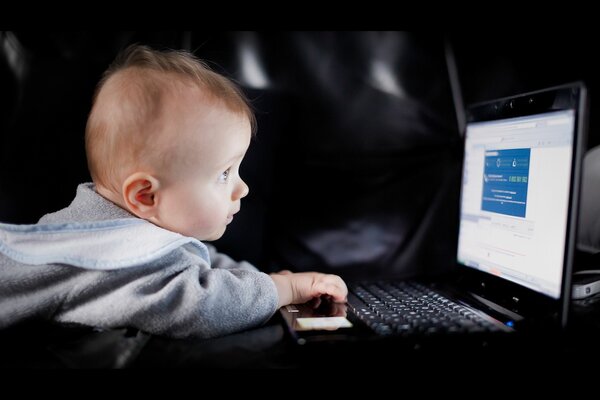 Baby helps Dad to work