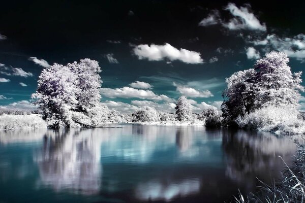 The reflection of clouds is visible in the lake