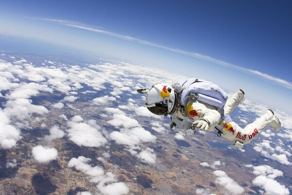 A parachutist athlete in the sky, above the clouds