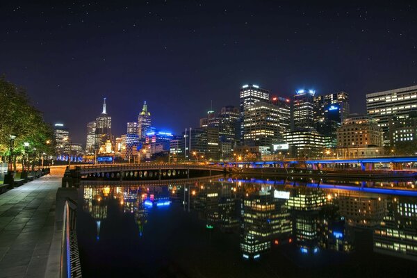 Night city on the background of a river channel