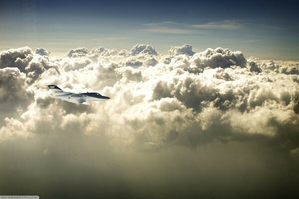 The plane flies above the clouds