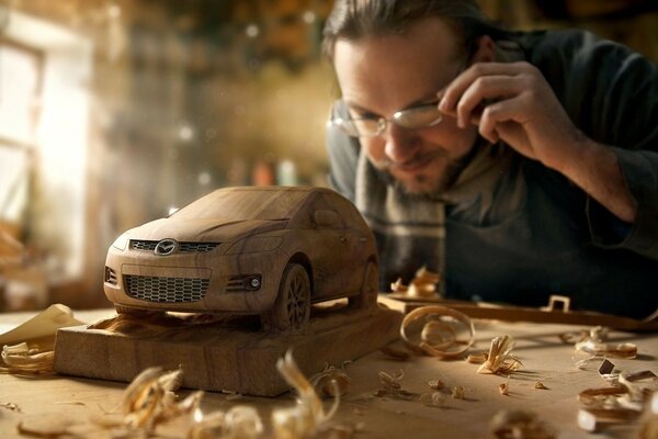 The master makes wooden cars