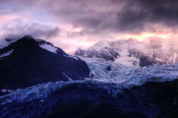 The fog spread over the snowy mountains