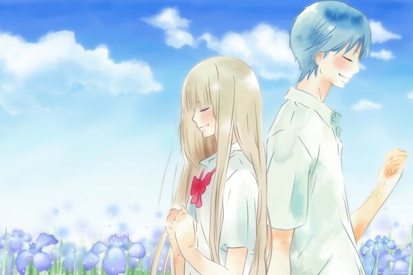 A young couple stands in a field of flowers