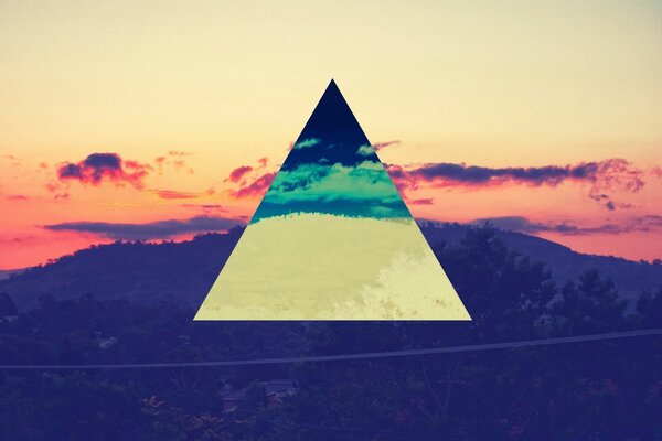 A pyramid between an endless road and a pink sunset