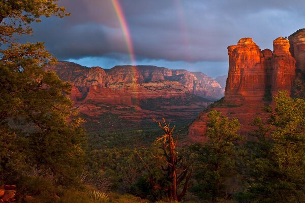 Rainbow in the sky over a beautiful canyon