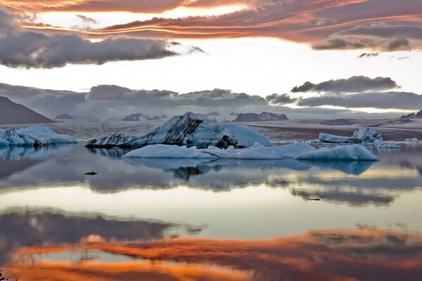 Landscape snowy mountains on the water