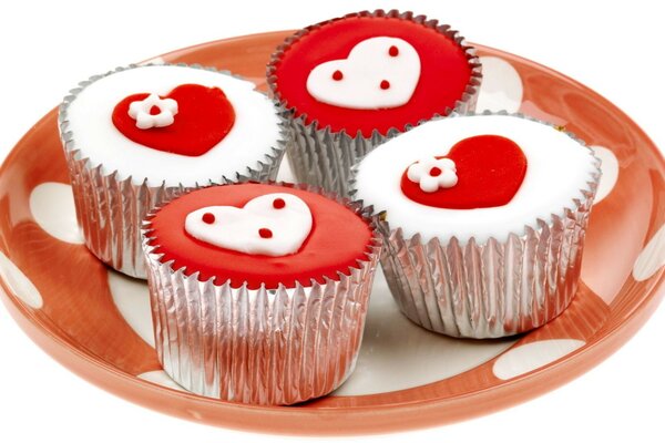 Cupcakes with a heart on a red plate