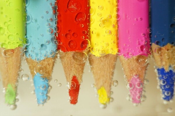 Colorful pencils under water