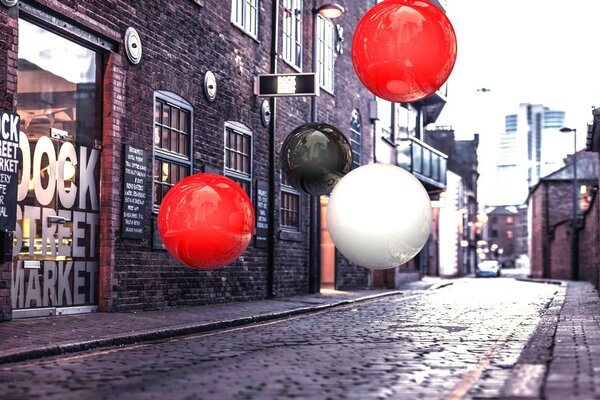 Colorful balloons on a cobblestone street