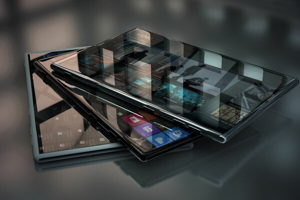 Three brand-new smartphones lying on a glass surface