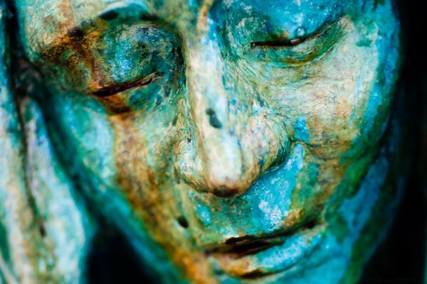 Face sculpture in blue and green