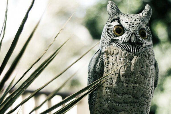 Stone sculpture of an owl in nature