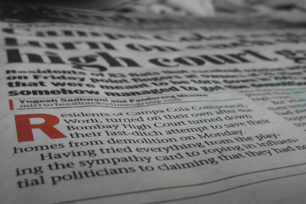 Photo of a newspaper at an angle with an accent letter