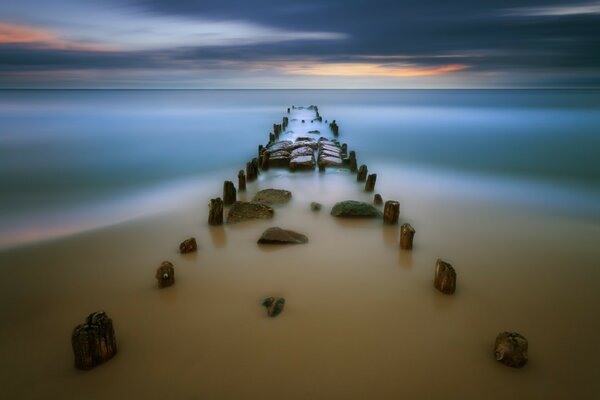 Construction of stones in the fog on the seashore