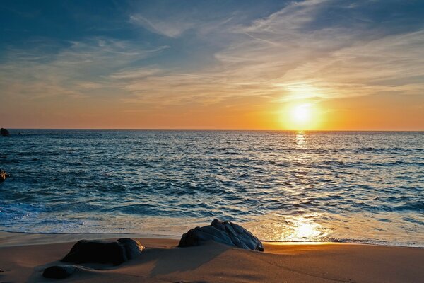 The sun at sunset over the sea surface