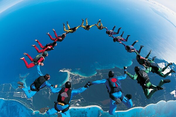 A group of parachutists high above the pond