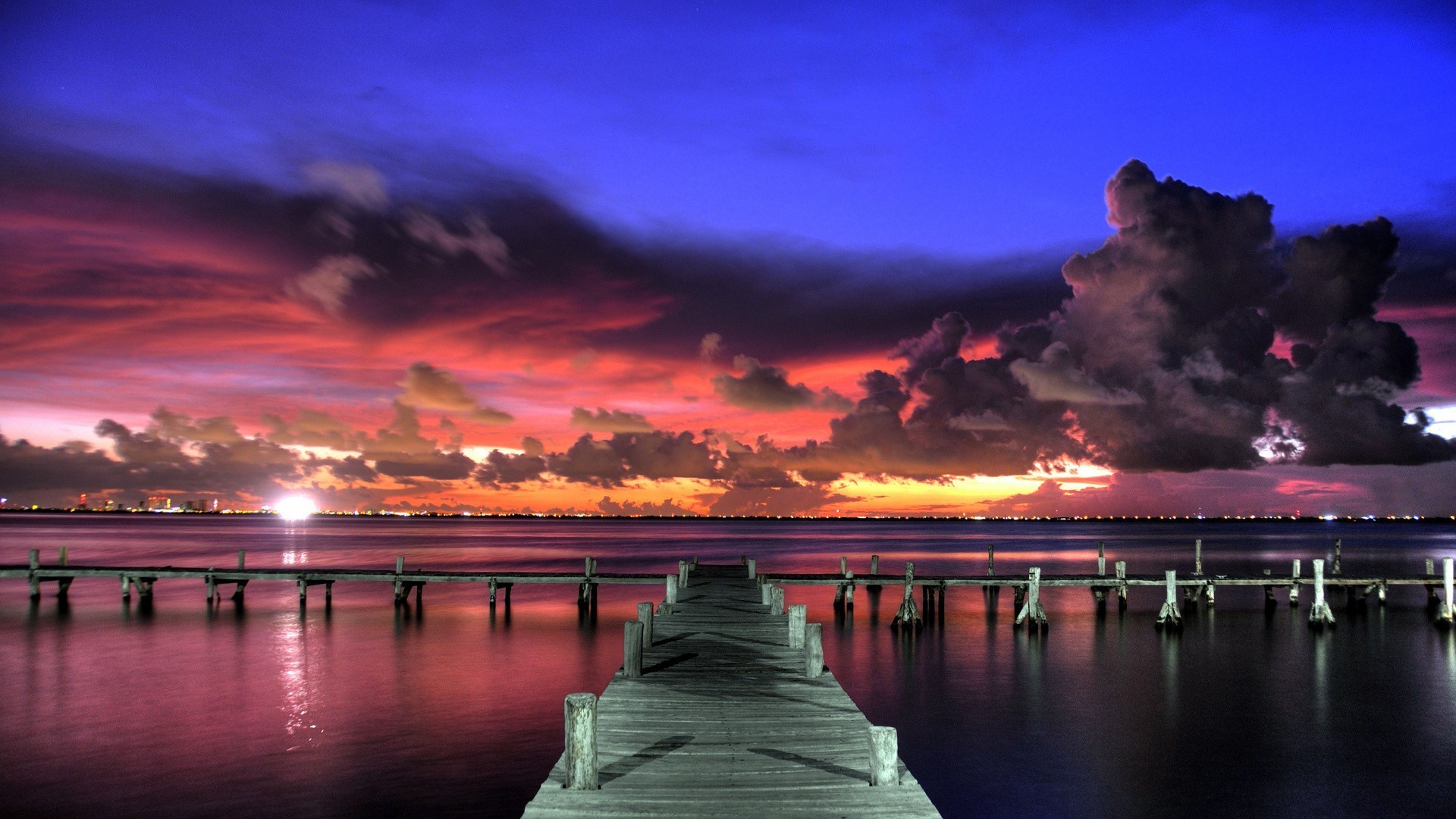 the sunset and sunrise sunset water dawn dusk evening reflection sky sea pier travel sun ocean beach bridge