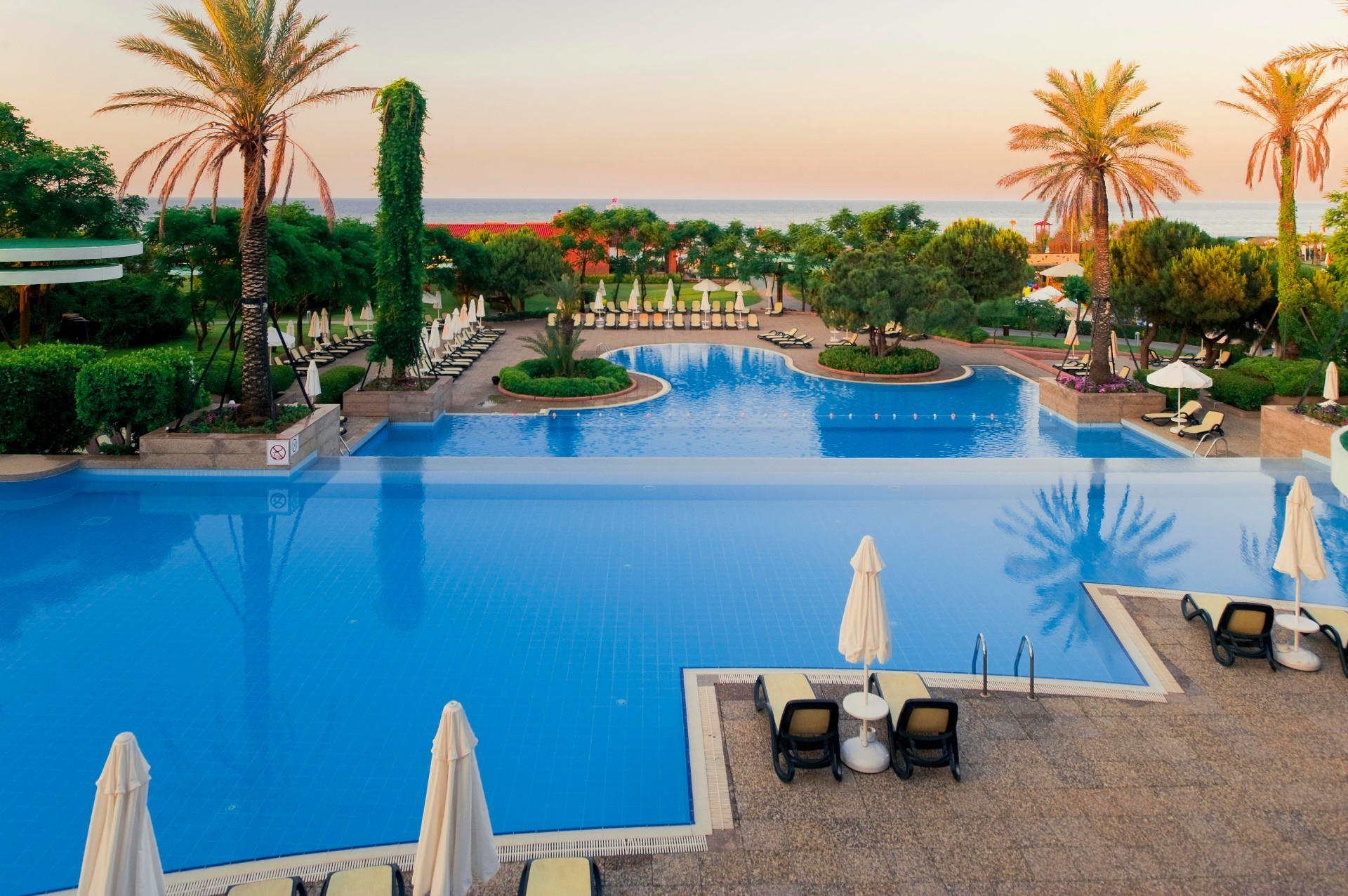 pools hotel resort pool swimming pool vacation luxury tropical swimming umbrella beach chair poolside travel palm relaxation water leisure summer exotic