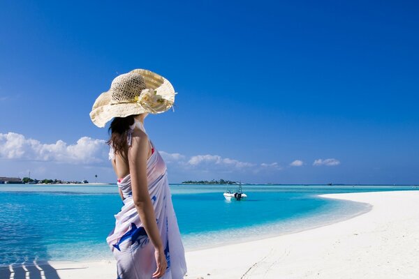 A girl in a swimsuit on the background of the beach