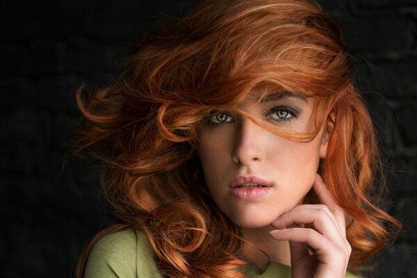 Red-haired girl on a dark background