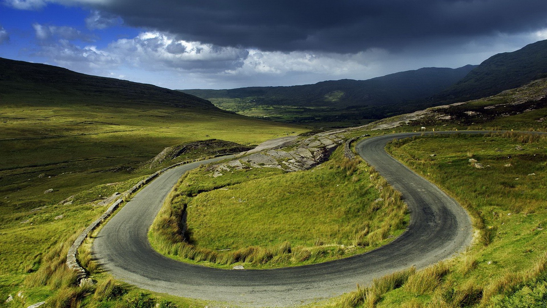 road landscape travel grass nature countryside outdoors rural sky scenic guidance field mountain curve hill asphalt highway