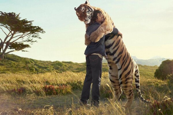 A man in the arms of a big tiger