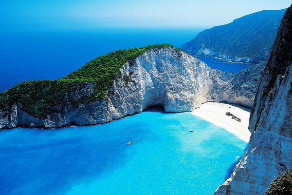 Ocean on the background of rocks and sandy beach