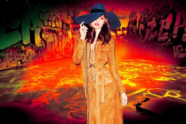 A girl in a hat on a background of fiery graphics