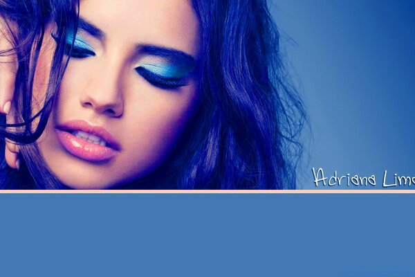 A girl with beautiful makeup on a blue background