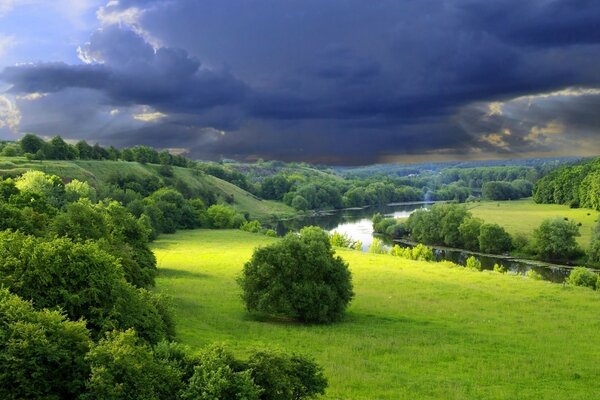 Picturesque fields above a stormy sky