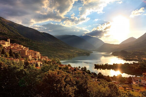 Dawn over a mountain lake and a small town