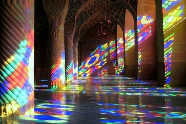 Colorful reflections on the walls of the palace from the sunlight pouring through the stained glass windows