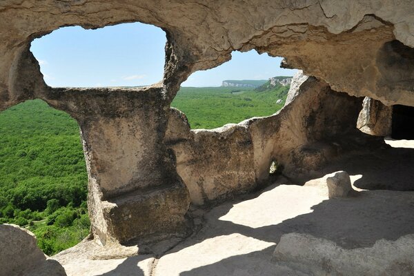 Caves tunnels bathed in the sun against the background of a green forest