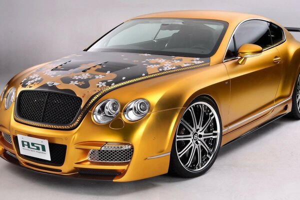 Gold-colored sports car with floral applique