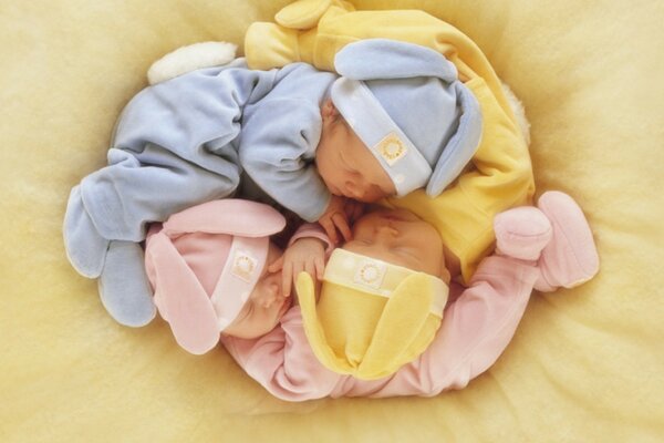 Three babies on a yellow background