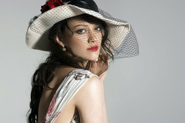 A girl in a hat with dark hair