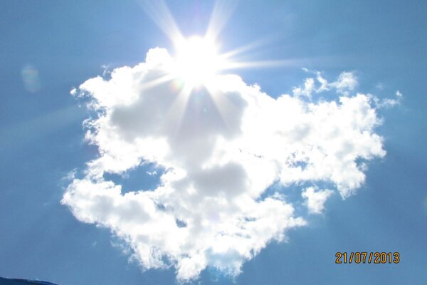 The sun breaks through a white cloud