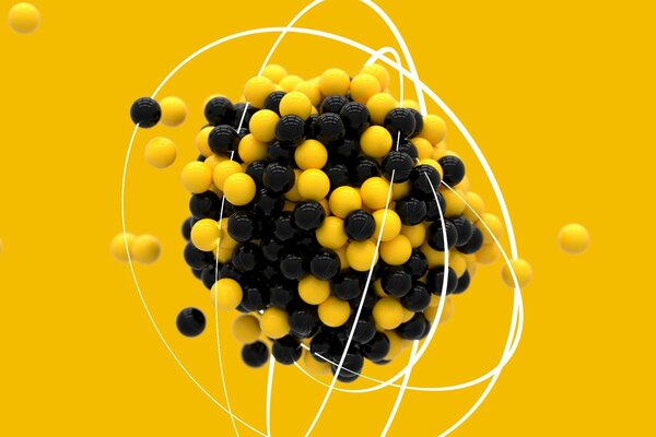 Yellow and black balls in the sign of the atom