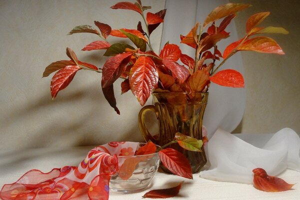 Still life of red leaves in a glass