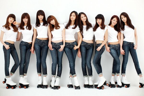 A group of girls in jeans and roller skates