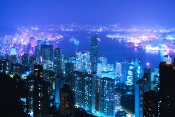 Bird s eye view at night of a big city with skyscrapers illuminated by lights